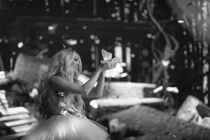 Country artist Carrie Underwood holding a butterfly